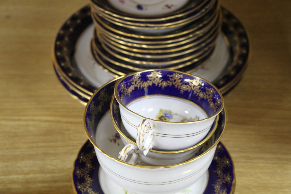 A Royal Worcester part tea service, painted with flower sprays by Ernest Phillips and Ernest Barker,